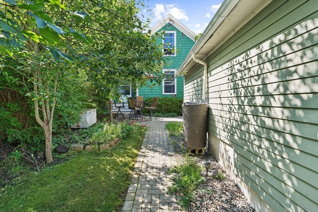 view of yard with a patio and central air condition unit