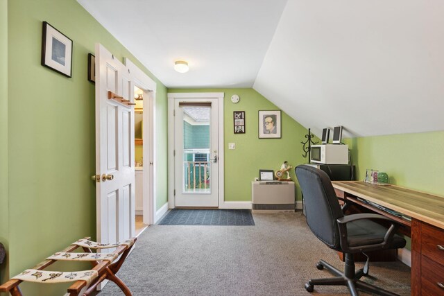 home office featuring lofted ceiling and carpet