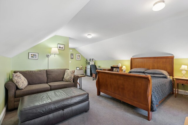 carpeted bedroom with lofted ceiling