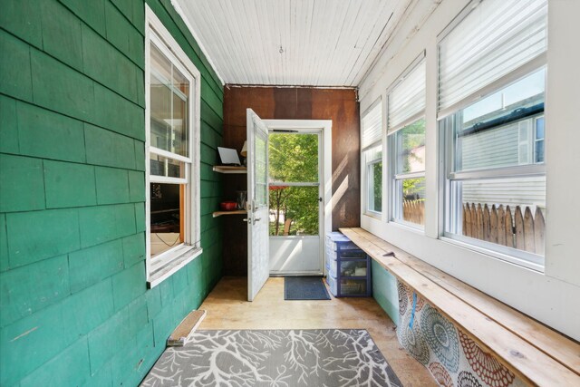 unfurnished sunroom with wood ceiling