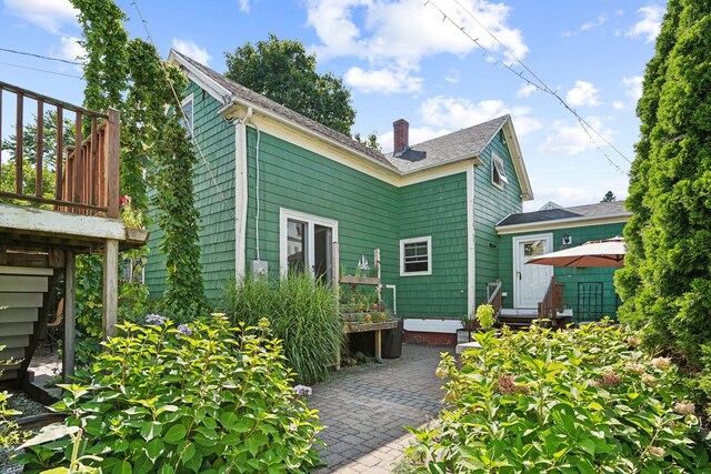 back of property with a patio and a deck