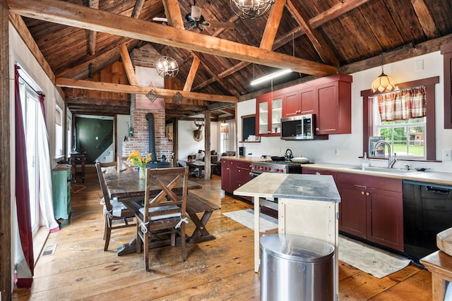 kitchen with beamed ceiling, appliances with stainless steel finishes, wooden ceiling, and light hardwood / wood-style floors