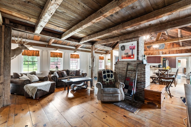 living room featuring wooden ceiling, beam ceiling, hardwood / wood-style flooring, and brick wall