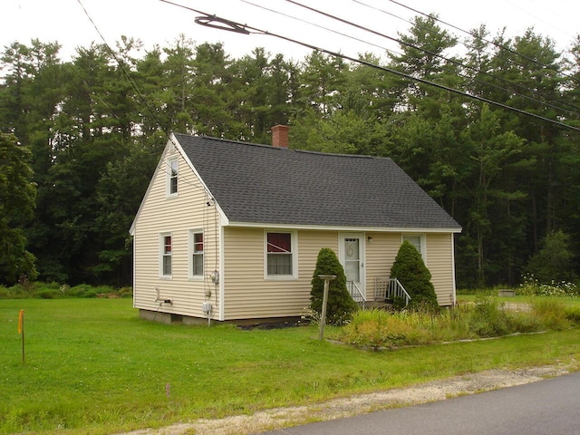 view of side of home featuring a lawn