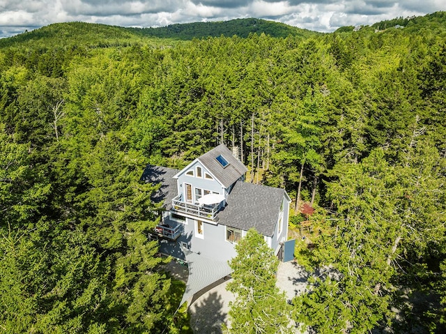 drone / aerial view featuring a wooded view