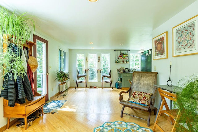 living area featuring light wood-style flooring and baseboards