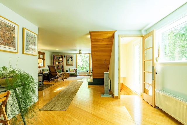 interior space with light wood finished floors and radiator