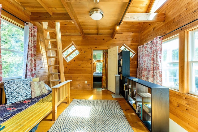 interior space featuring wood walls, wooden ceiling, wood finished floors, and beam ceiling