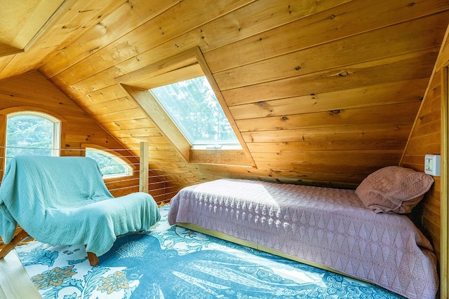 bedroom with lofted ceiling with skylight, wood ceiling, and wooden walls