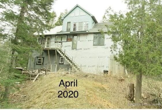 back of house featuring stairs