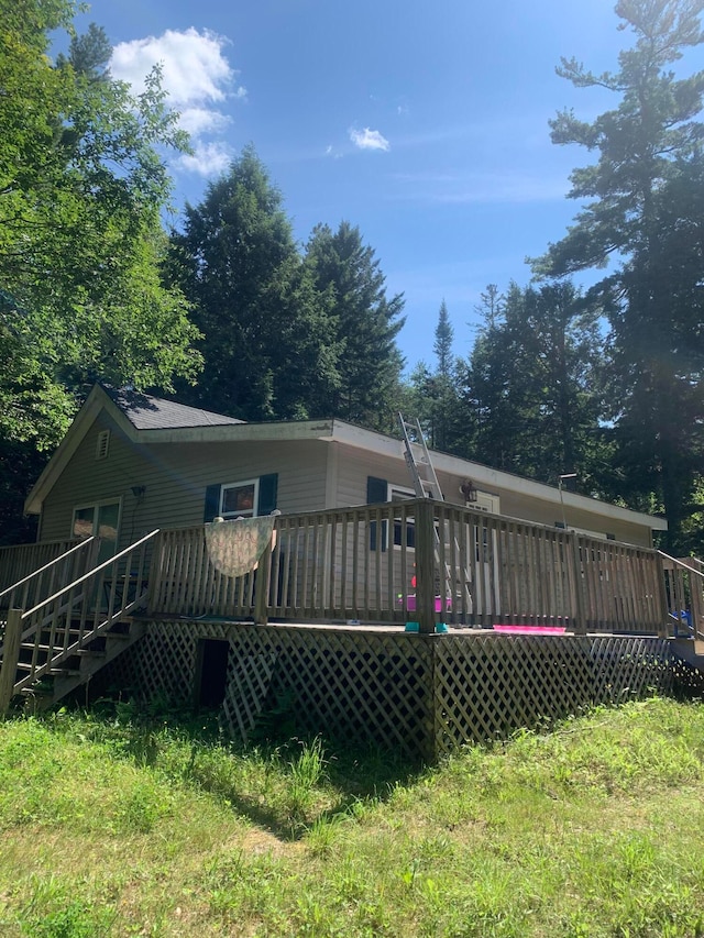 back of house with a wooden deck