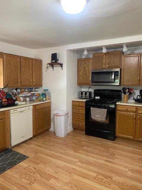 kitchen featuring light hardwood / wood-style floors, gas stove, and white dishwasher