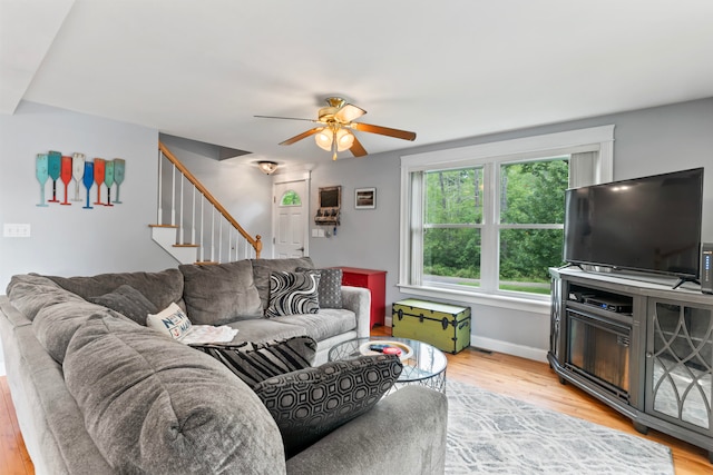 living room featuring ceiling fan and light wood-type flooring