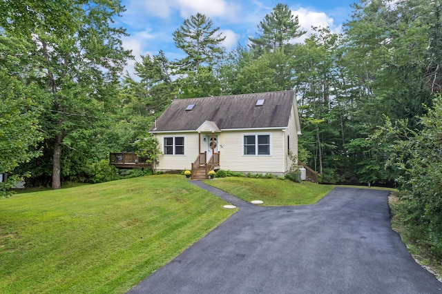 cape cod-style house with a wooden deck and a front lawn