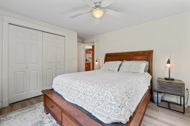 bedroom with a closet, ceiling fan, and light hardwood / wood-style floors