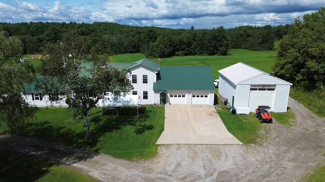 view of front of house with a front lawn, a garage, and an outbuilding