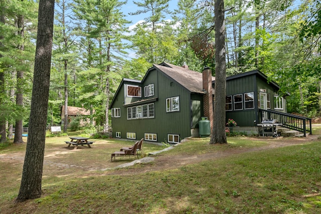 view of side of home with a lawn