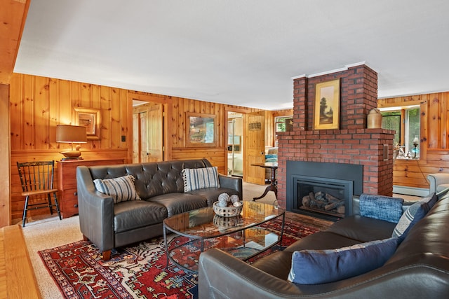 living room with wood walls, brick wall, and a fireplace