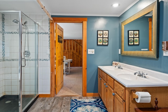 bathroom featuring a shower with door, vanity, and wood-type flooring