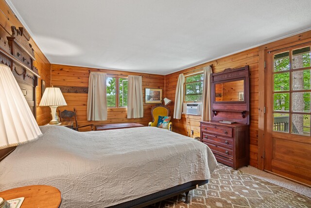 bedroom featuring carpet, multiple windows, and cooling unit