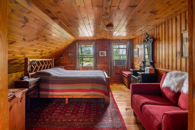 bedroom with light wood-type flooring, wood ceiling, wooden walls, cooling unit, and lofted ceiling