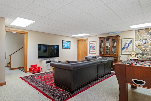 tiled living room featuring a paneled ceiling