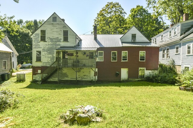 rear view of property with a lawn