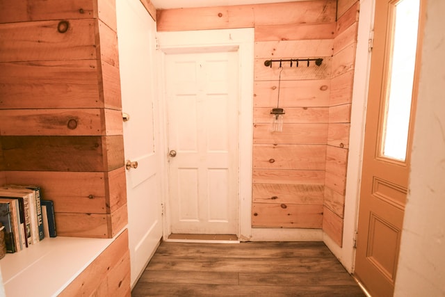 interior space with wood walls and hardwood / wood-style flooring