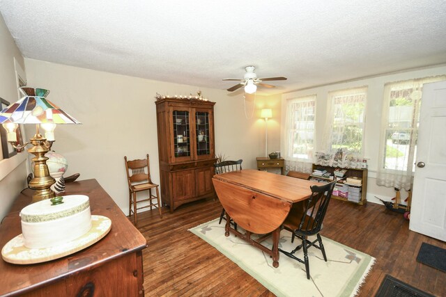 dining space with a textured ceiling, dark hardwood / wood-style flooring, and ceiling fan