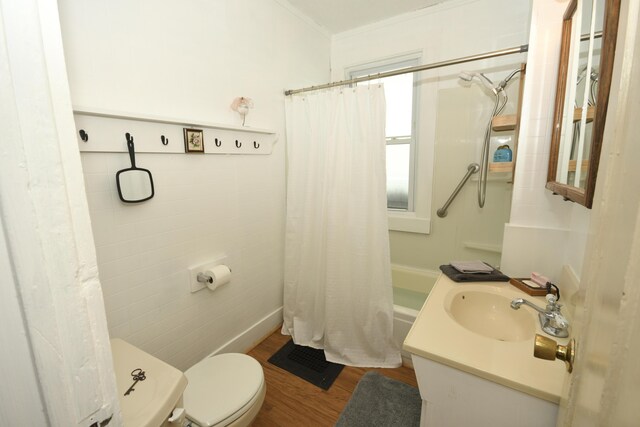 full bathroom featuring shower / bath combo, hardwood / wood-style floors, crown molding, vanity, and toilet