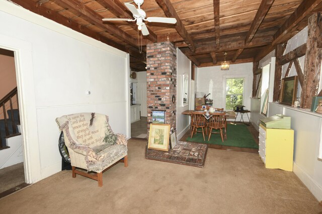 interior space with wooden ceiling, carpet, beamed ceiling, and ceiling fan