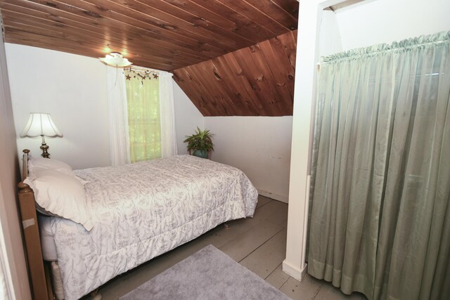 bedroom with wood ceiling and vaulted ceiling