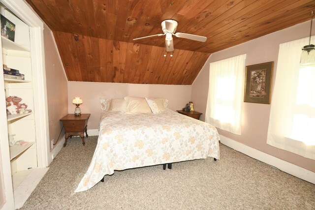 carpeted bedroom with ceiling fan, vaulted ceiling, and wooden ceiling