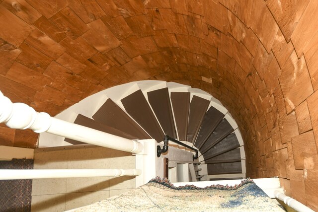 stairway featuring lofted ceiling