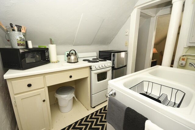 kitchen featuring vaulted ceiling and white gas range