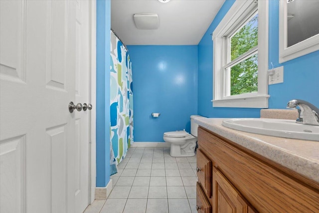 bathroom featuring walk in shower, tile patterned flooring, vanity, and toilet