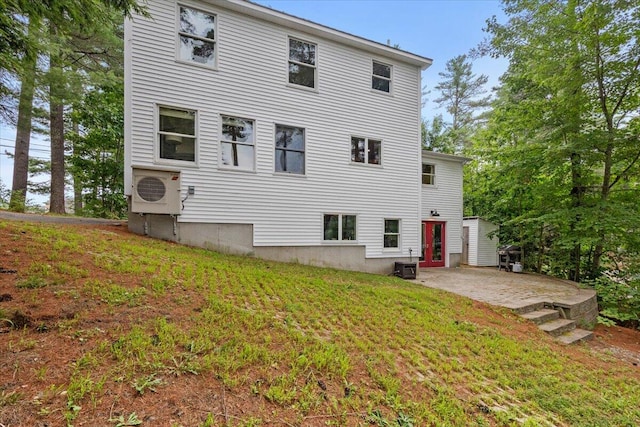 back of house with a lawn, a patio area, central air condition unit, and ac unit