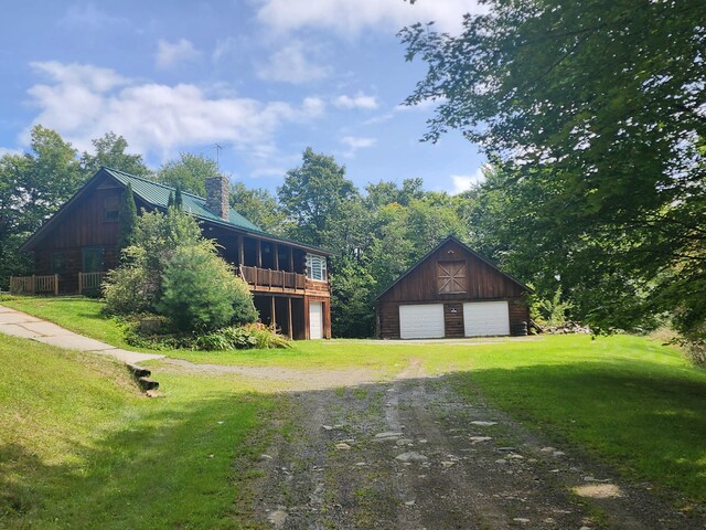 view of property exterior featuring a garage and an outbuilding