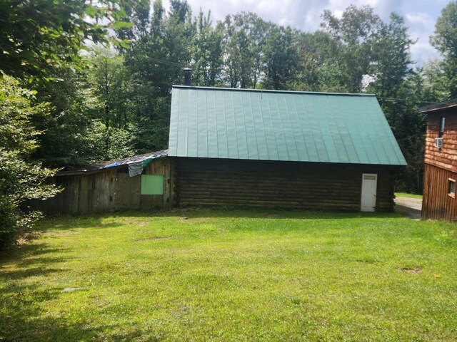 view of outbuilding with a lawn