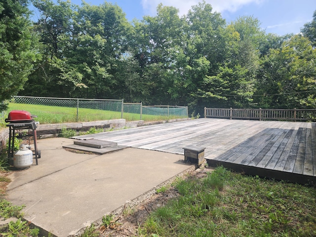 exterior space featuring a deck and a grill