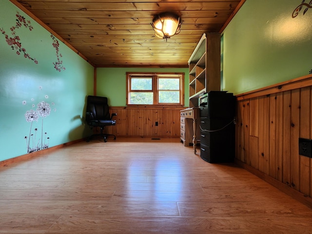 interior space featuring lofted ceiling, light hardwood / wood-style floors, wood walls, and wooden ceiling