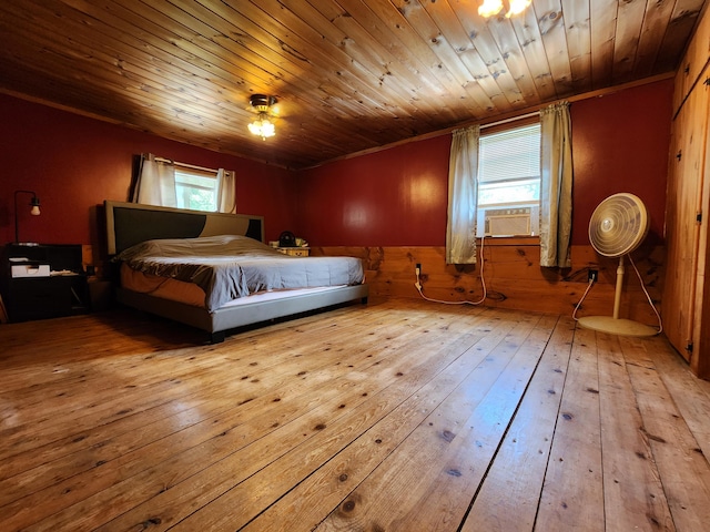 bedroom with light wood-type flooring, cooling unit, and wooden ceiling