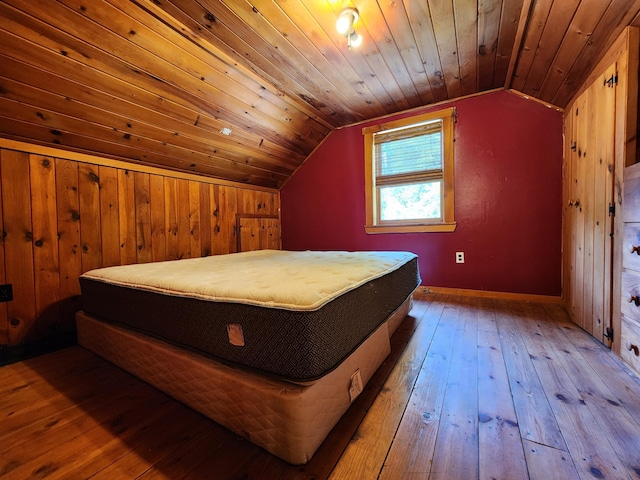 bedroom featuring hardwood / wood-style floors, vaulted ceiling, and wooden ceiling