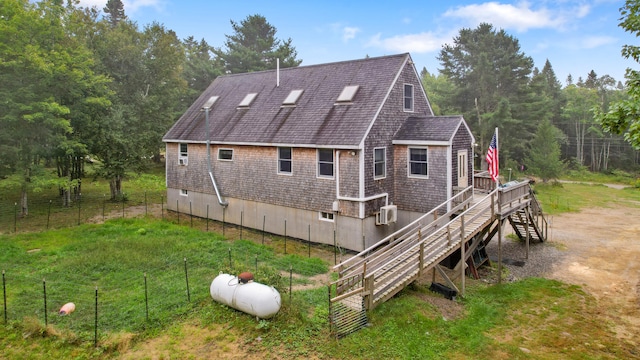 rear view of house featuring a wall mounted air conditioner