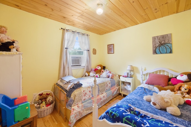 bedroom featuring cooling unit, hardwood / wood-style flooring, and wooden ceiling