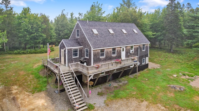 rear view of property featuring a wooden deck