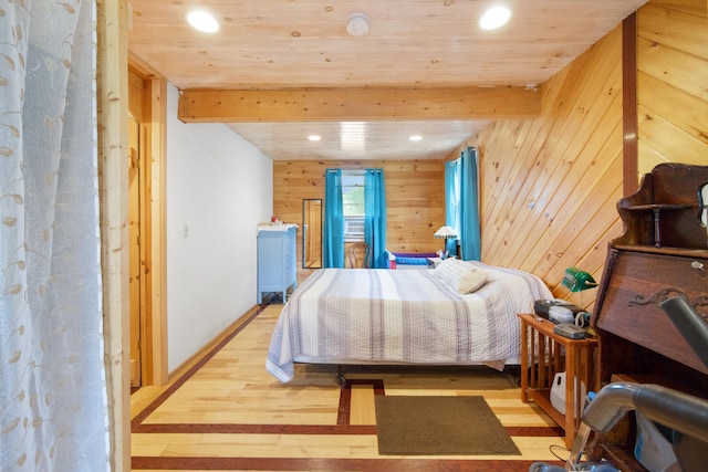 bedroom featuring wooden walls, beam ceiling, wooden ceiling, and light hardwood / wood-style flooring