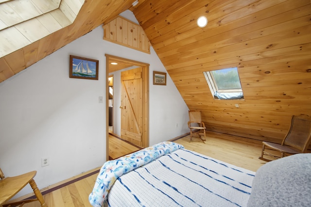 bedroom featuring light wood-type flooring, wood ceiling, and lofted ceiling with skylight