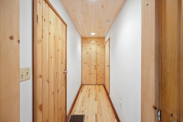 hall with wooden ceiling and light wood-type flooring