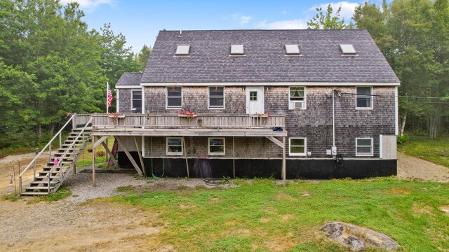 back of house with a deck and a yard